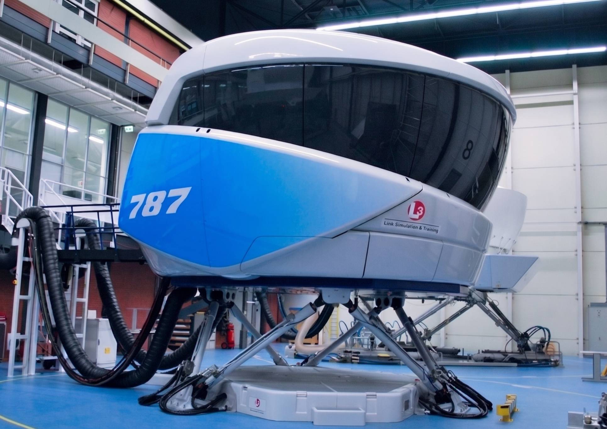 Boeing 787 full-flight simulator on its motion platform in a training facility.